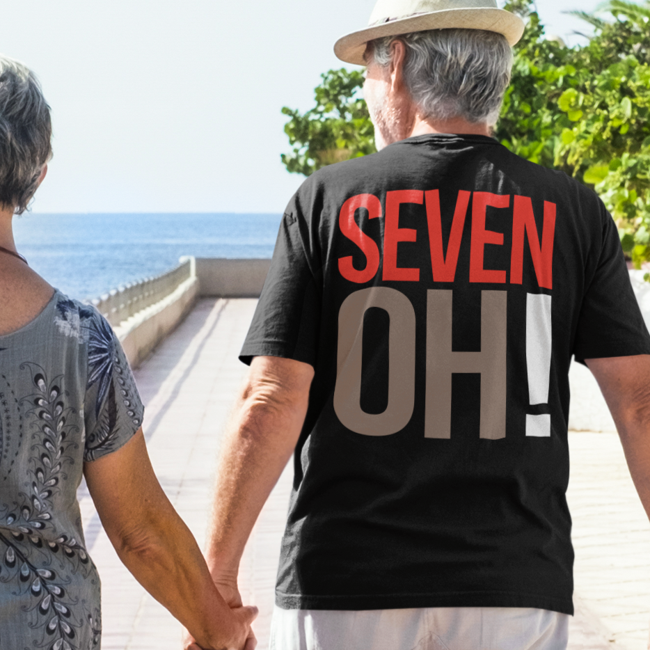 elder wearing 70th Birthday Gift T-shirt, SEVEN OH! on back, Unisex