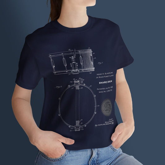 Person wearing a navy blue t-shirt with a drum design on a dark background