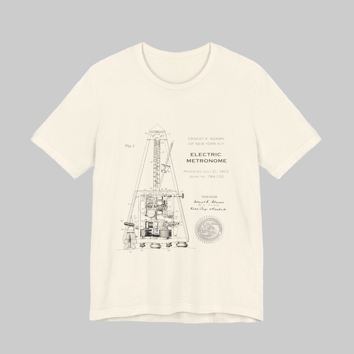 Beige t-shirt with black technical drawing and text on a white background