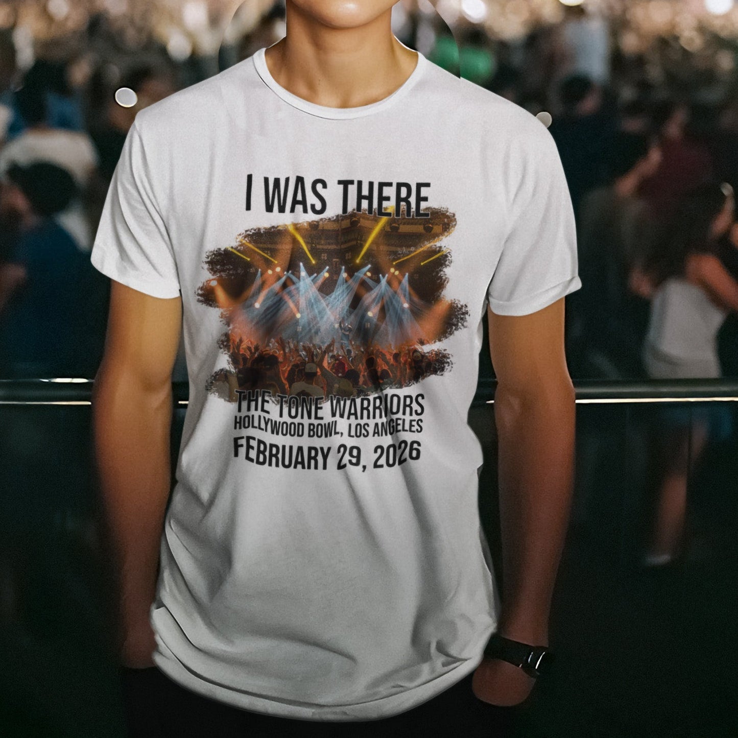Person wearing a t-shirt at a concert with event details printed on it.