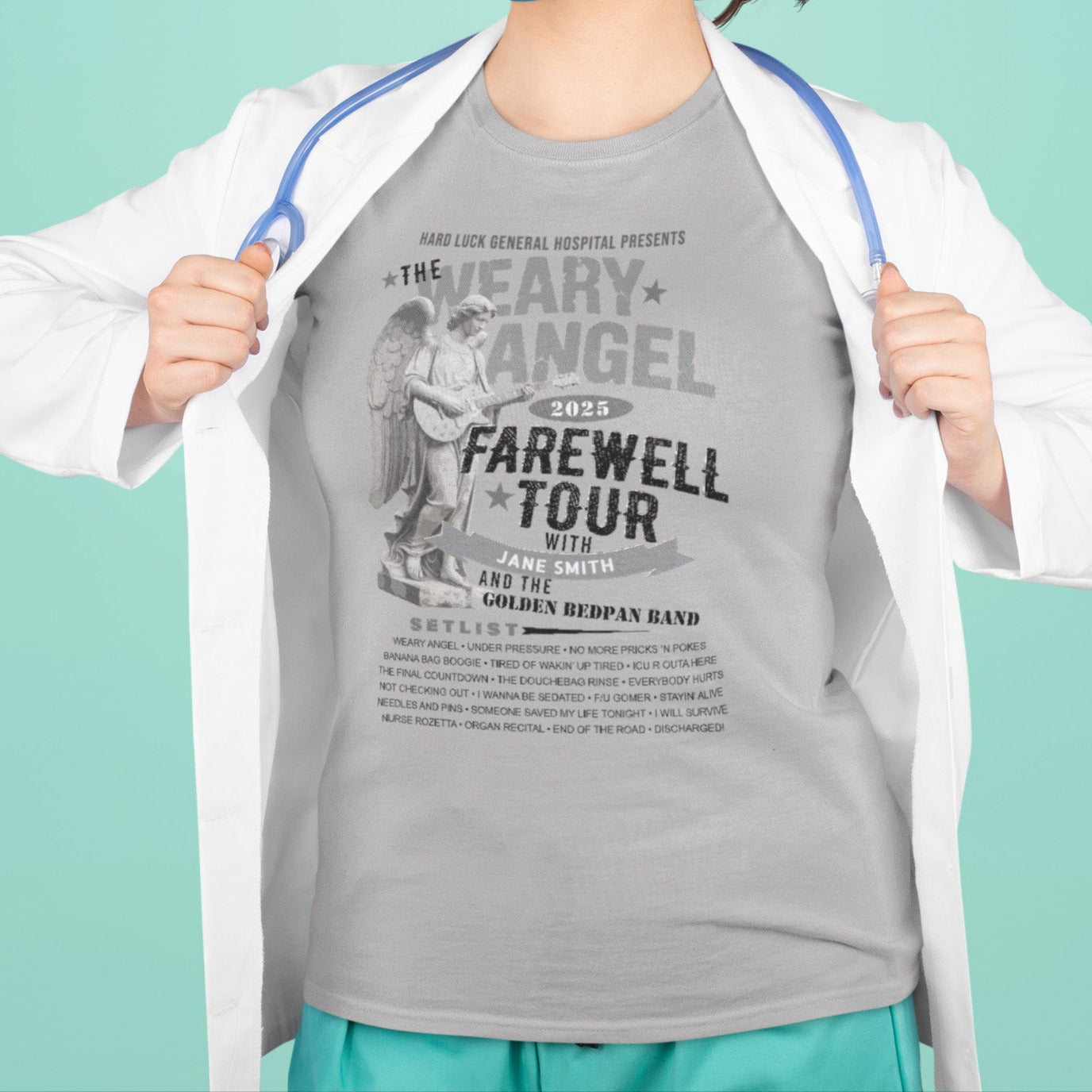 Person wearing a gray t-shirt with text and a white coat over shoulders against a teal background