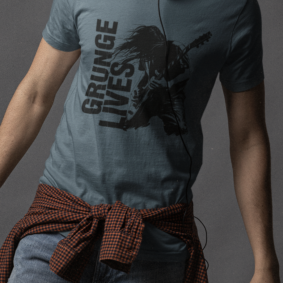 Man wearing a gray t-shirt with text and graphics, standing against a dark background