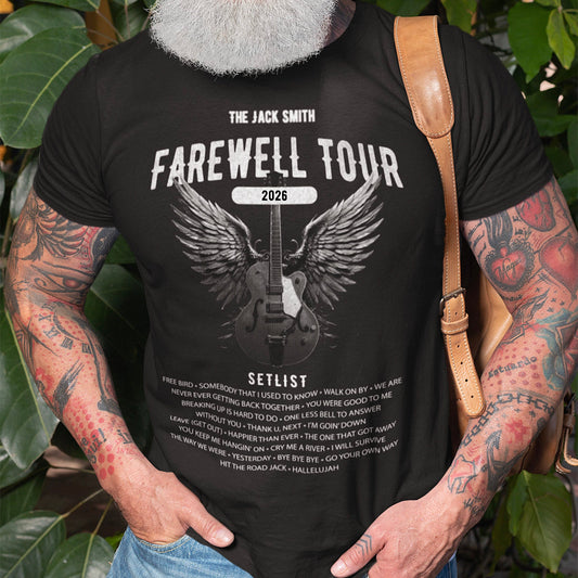 Man wearing a black retirement t-shirt with 'The Jack Smith Farewell Tour 2026' design, standing outdoors with greenery.