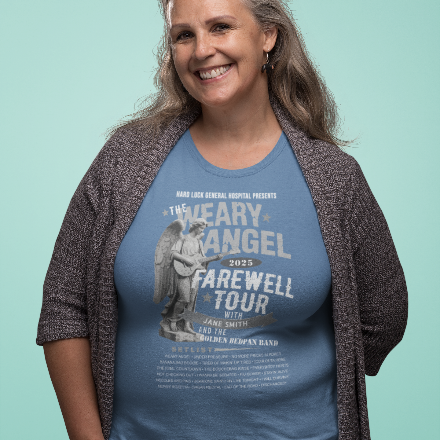 Woman wearing a blue t-shirt with text and graphics on a light green background