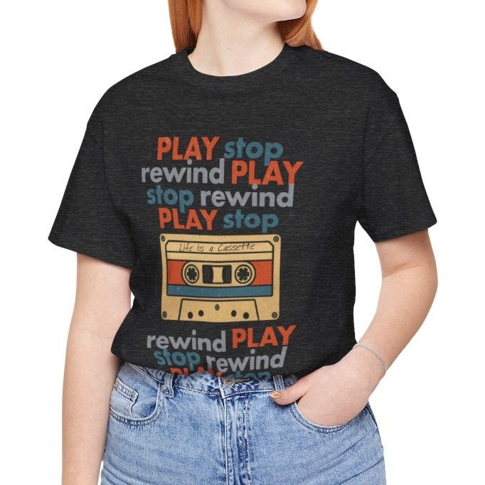 girl wearing a black t-shirt with a colorful cassette tape graphic and text on a white background