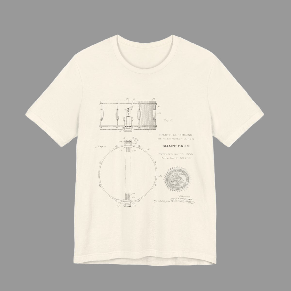Beige t-shirt with drum design on a white background