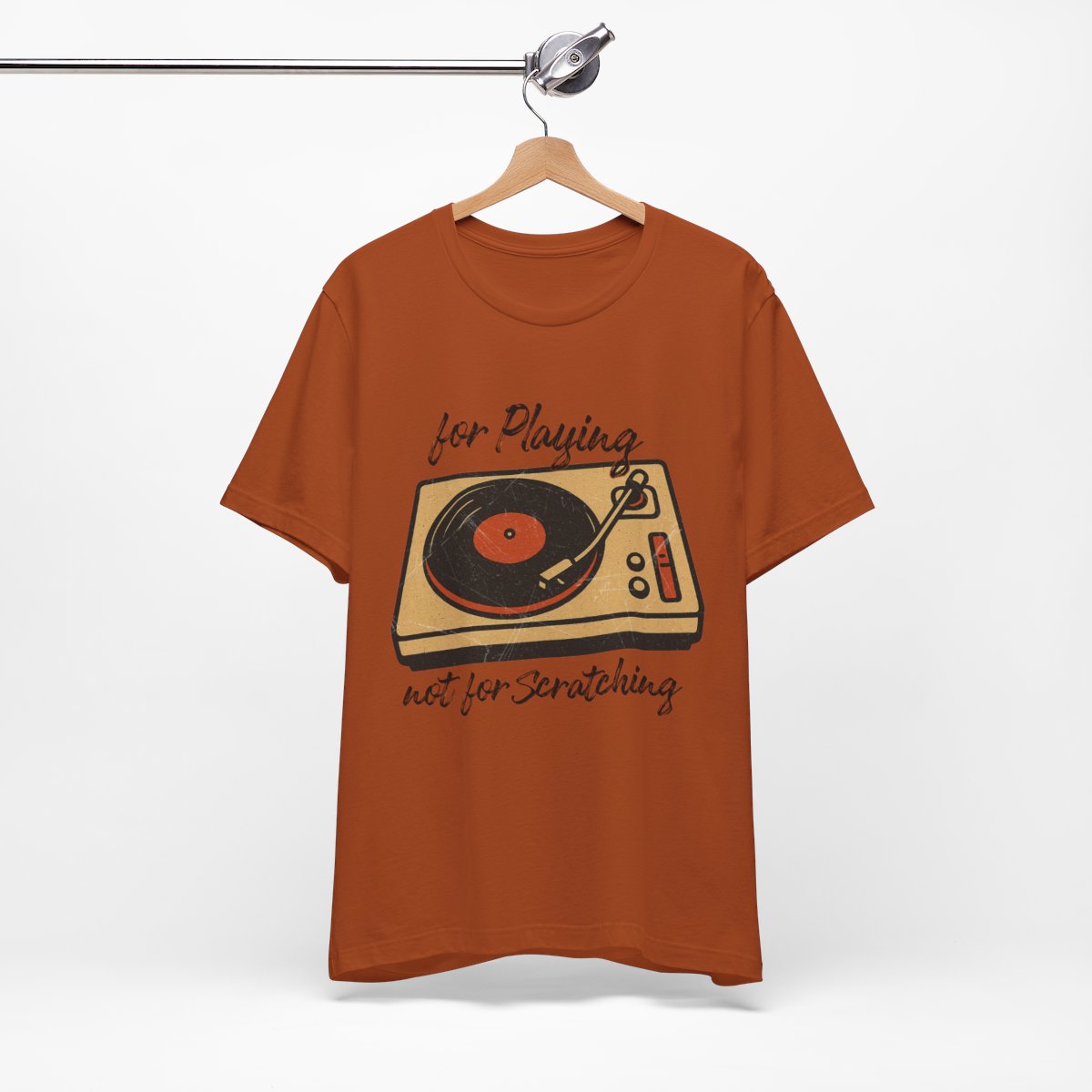 Orange t-shirt with a graphic of a turntable and text on a hanger against a white background