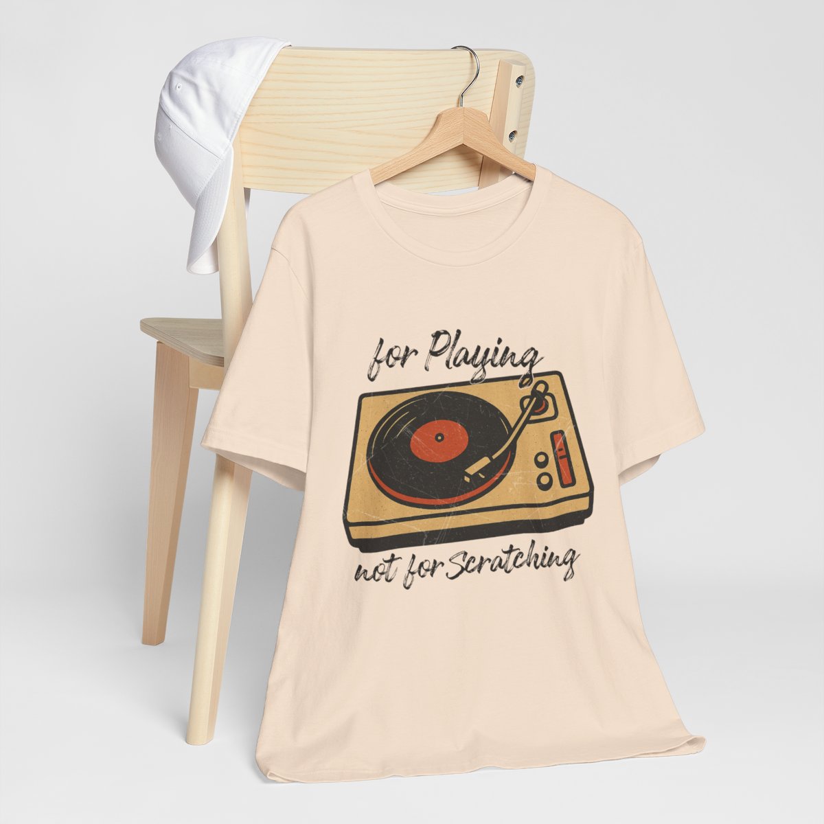 Beige t-shirt with a graphic design and text on a white background